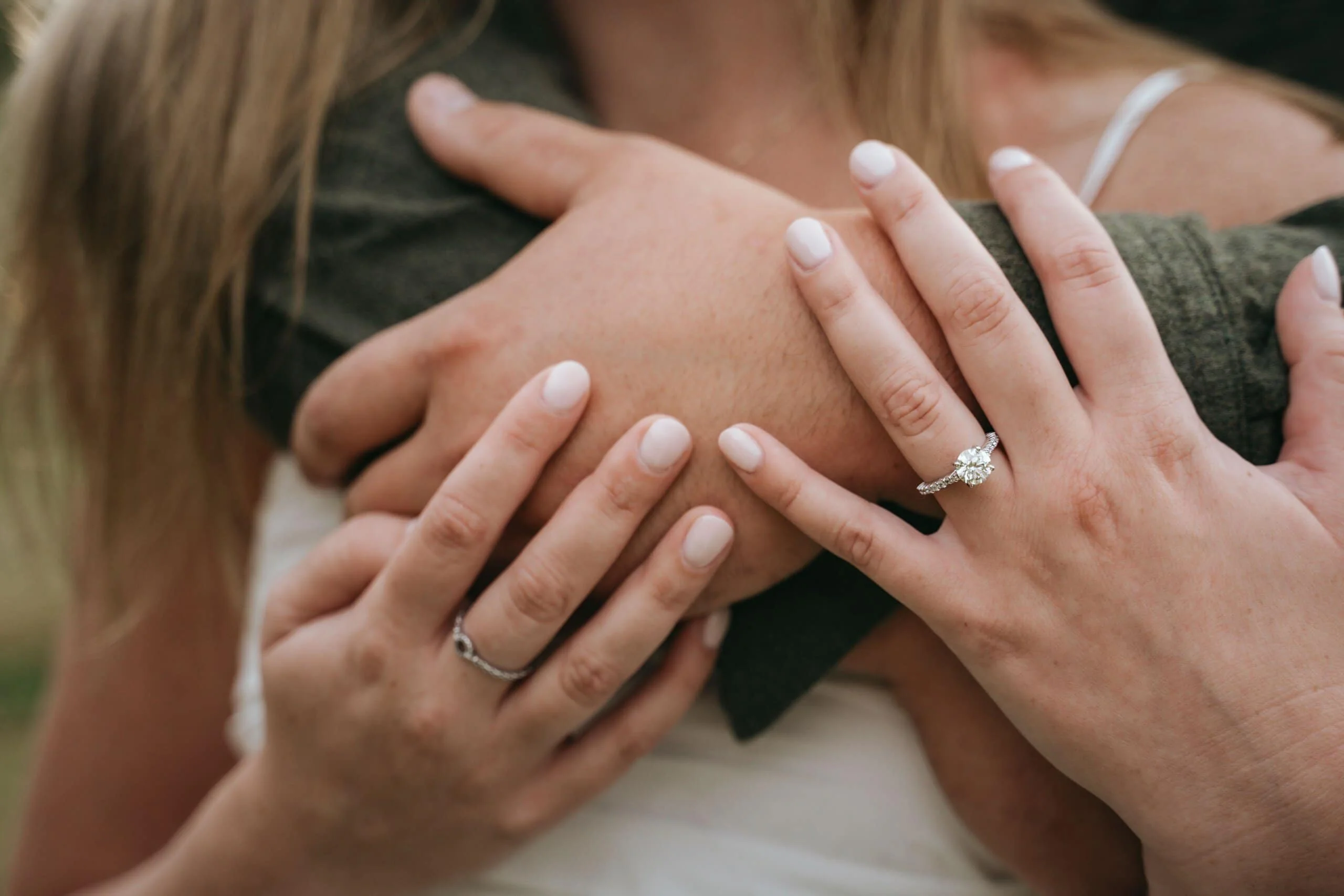 Engagement Ring Detail After Proposal Close-up of engagement ring on woman’s hand embracing partner after Smoky Mountains proposal