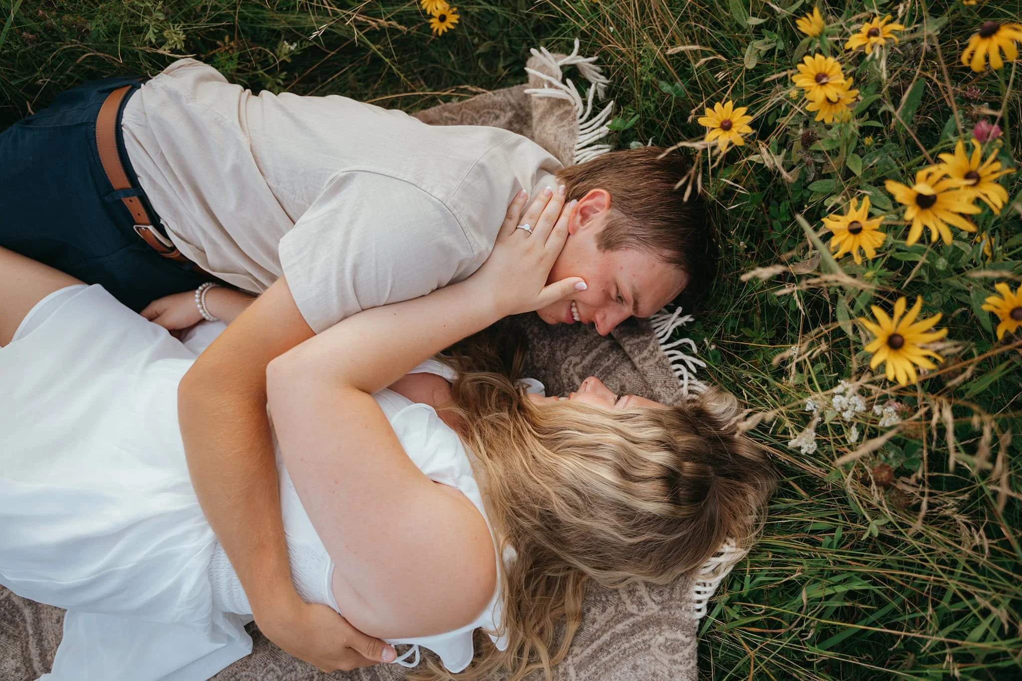 DSC05856 Playful engaged couple lying together in a wildflower field after Smoky Mountains proposal
