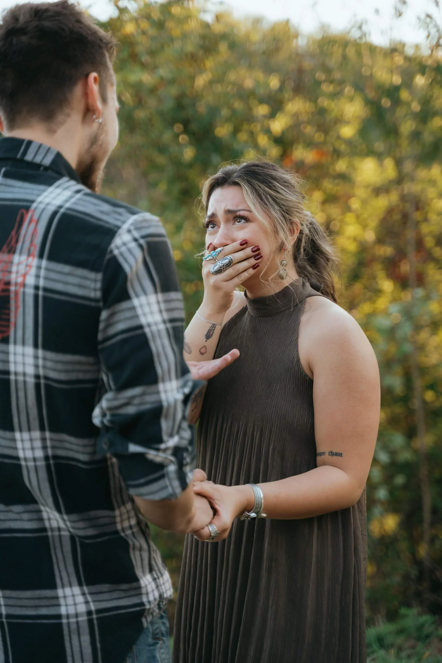 Emotional Surprise Proposal Reaction Emotional surprise proposal moment with woman covering her mouth in shock during engagement in the Smoky Mountains