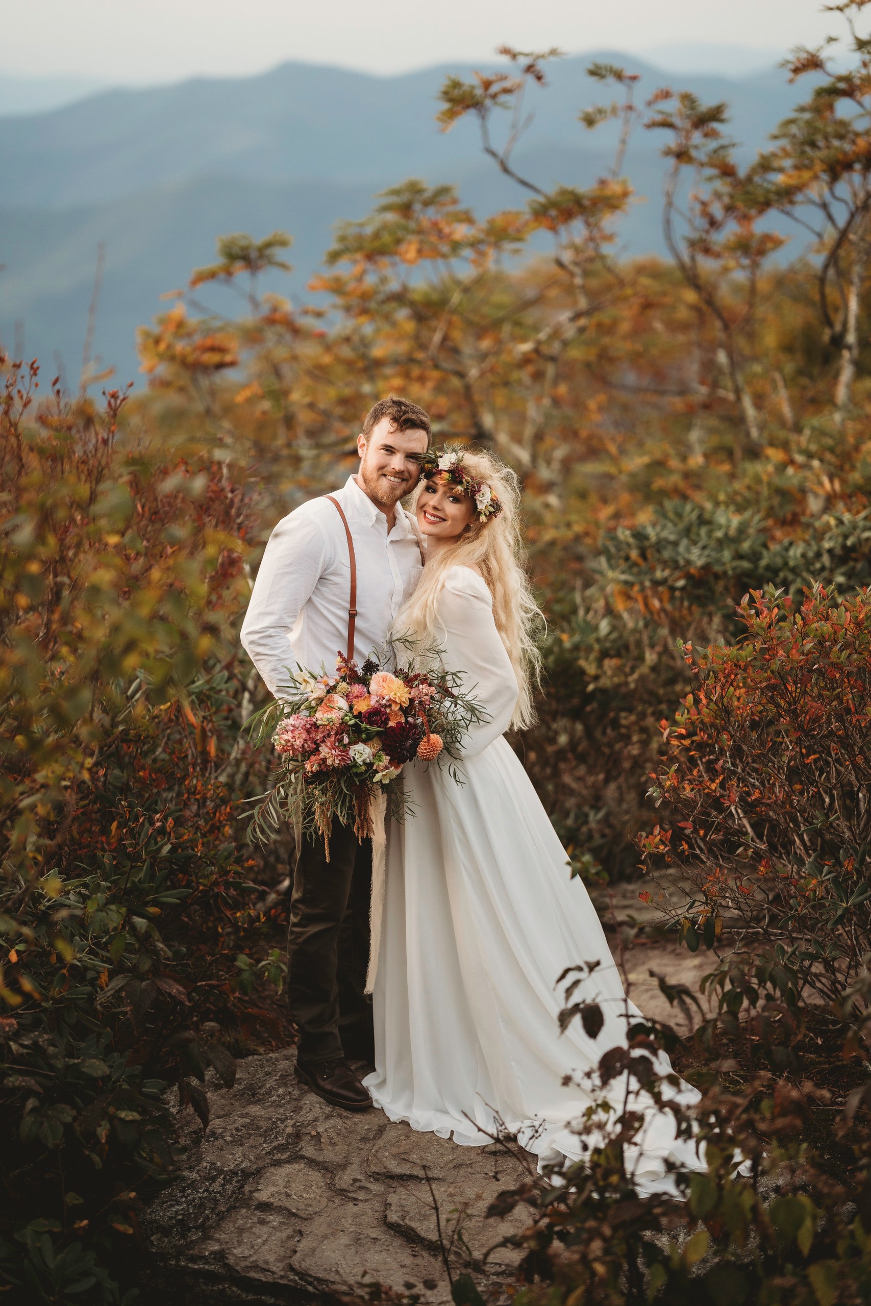 married couple in the mountains during fall season