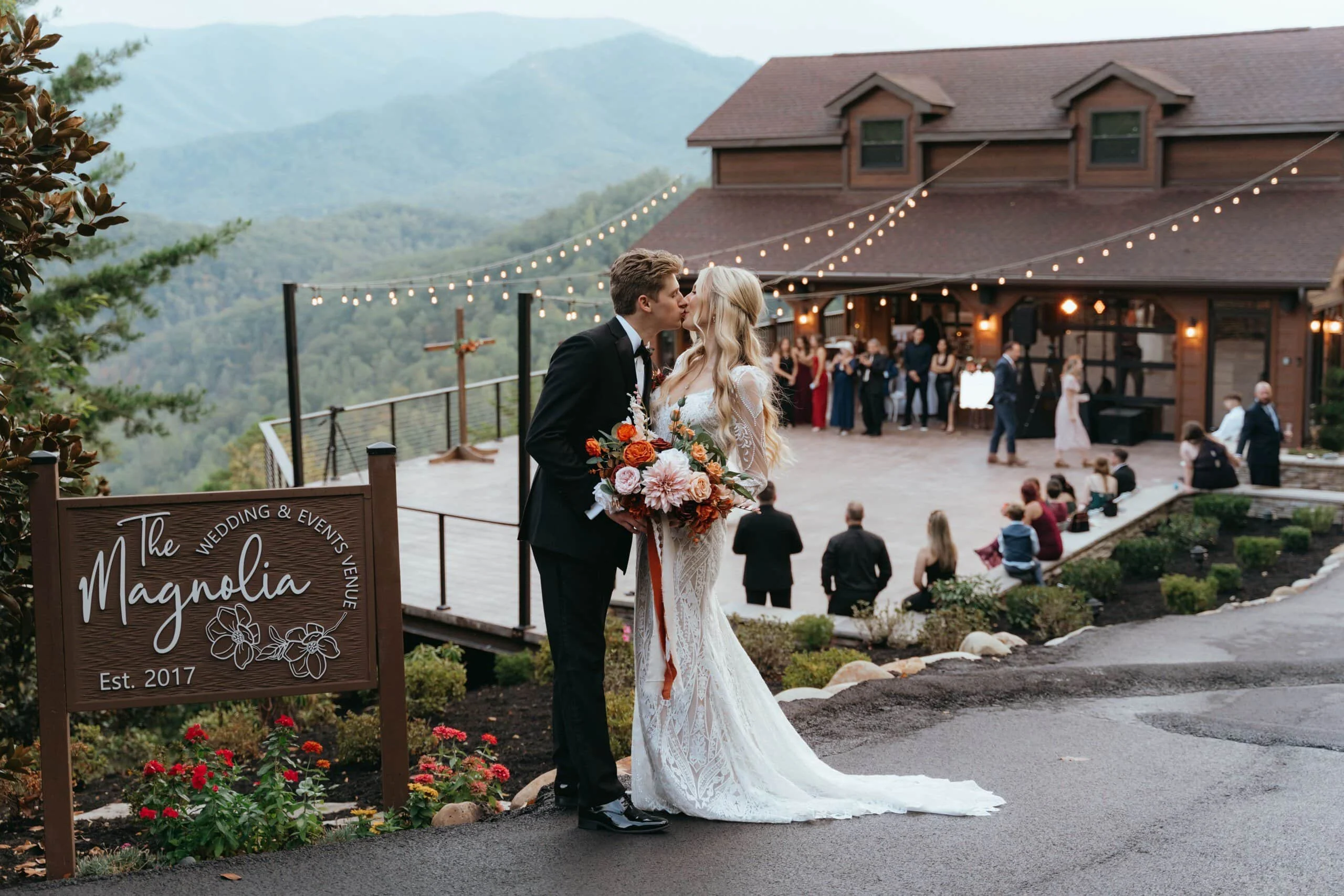 Smoky mountains Tennessee Mountain Wedding Venue Couple Portrait Bride and groom kissing at a mountain view wedding venue in Pigeon forge , Tennessee during their outdoor ceremony reception.