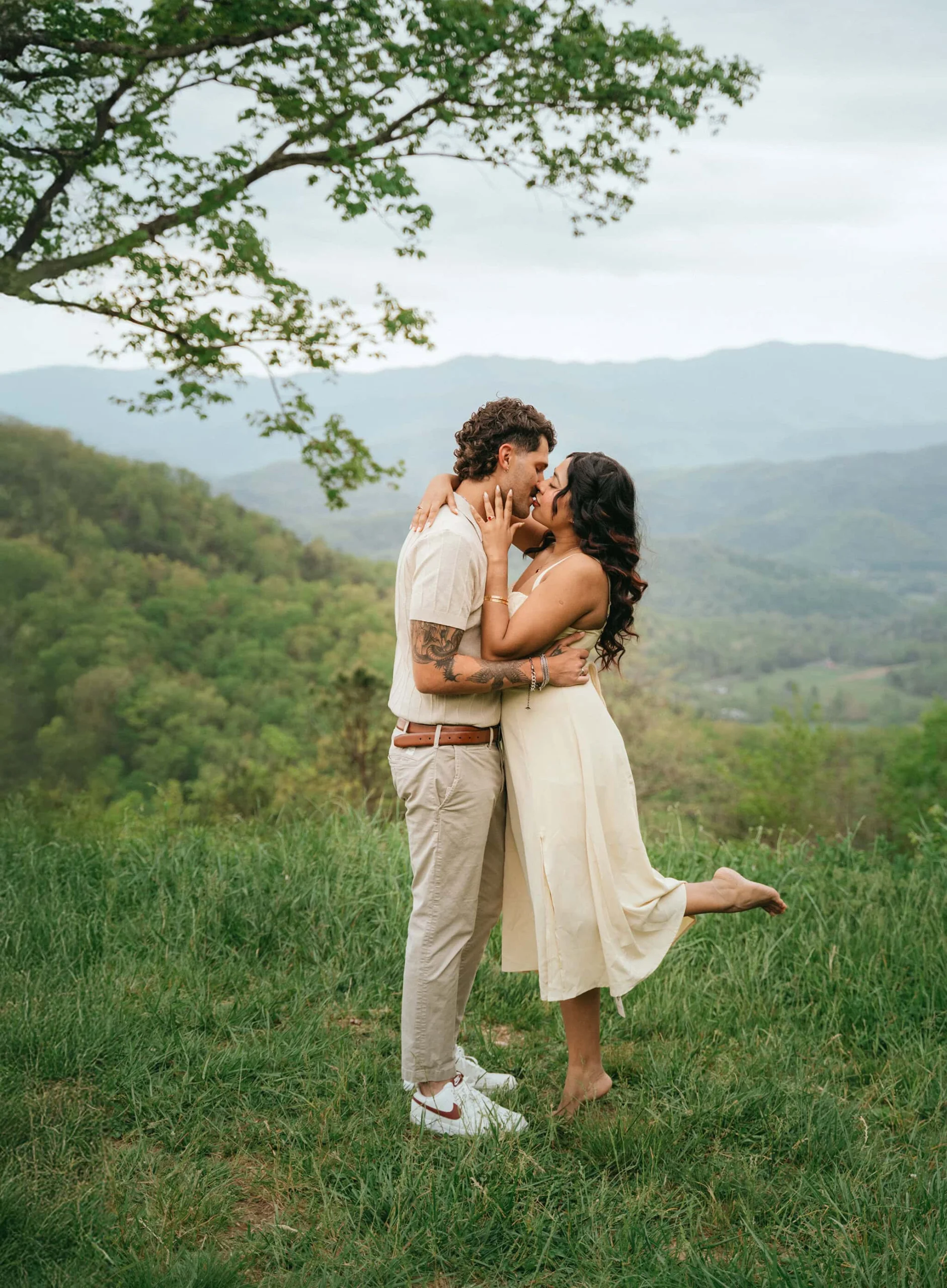 Couple is kissing after surprise proposal at Foothills parkway