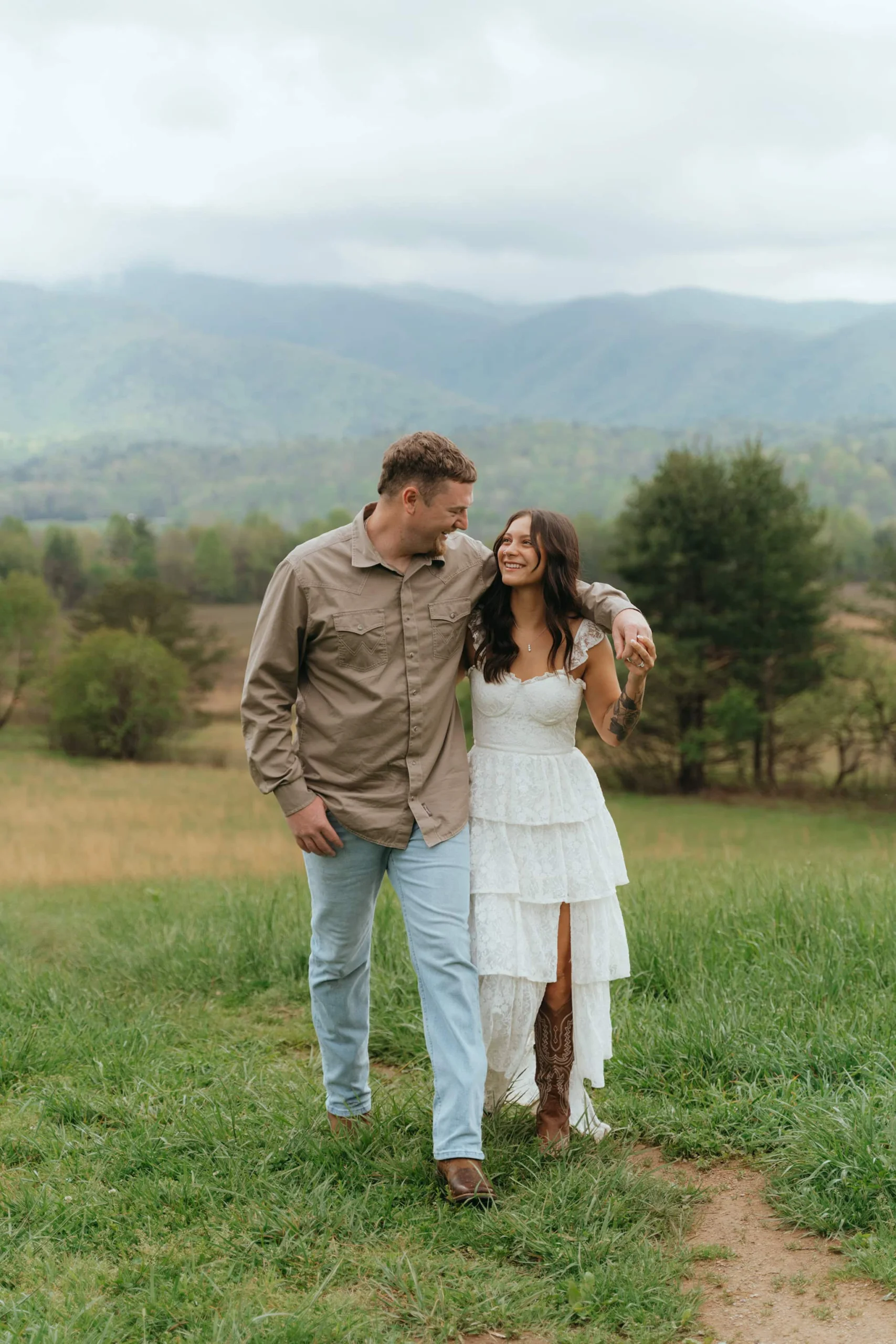 Couple is walking in a field of Wild life overlook in the Smoky mountains