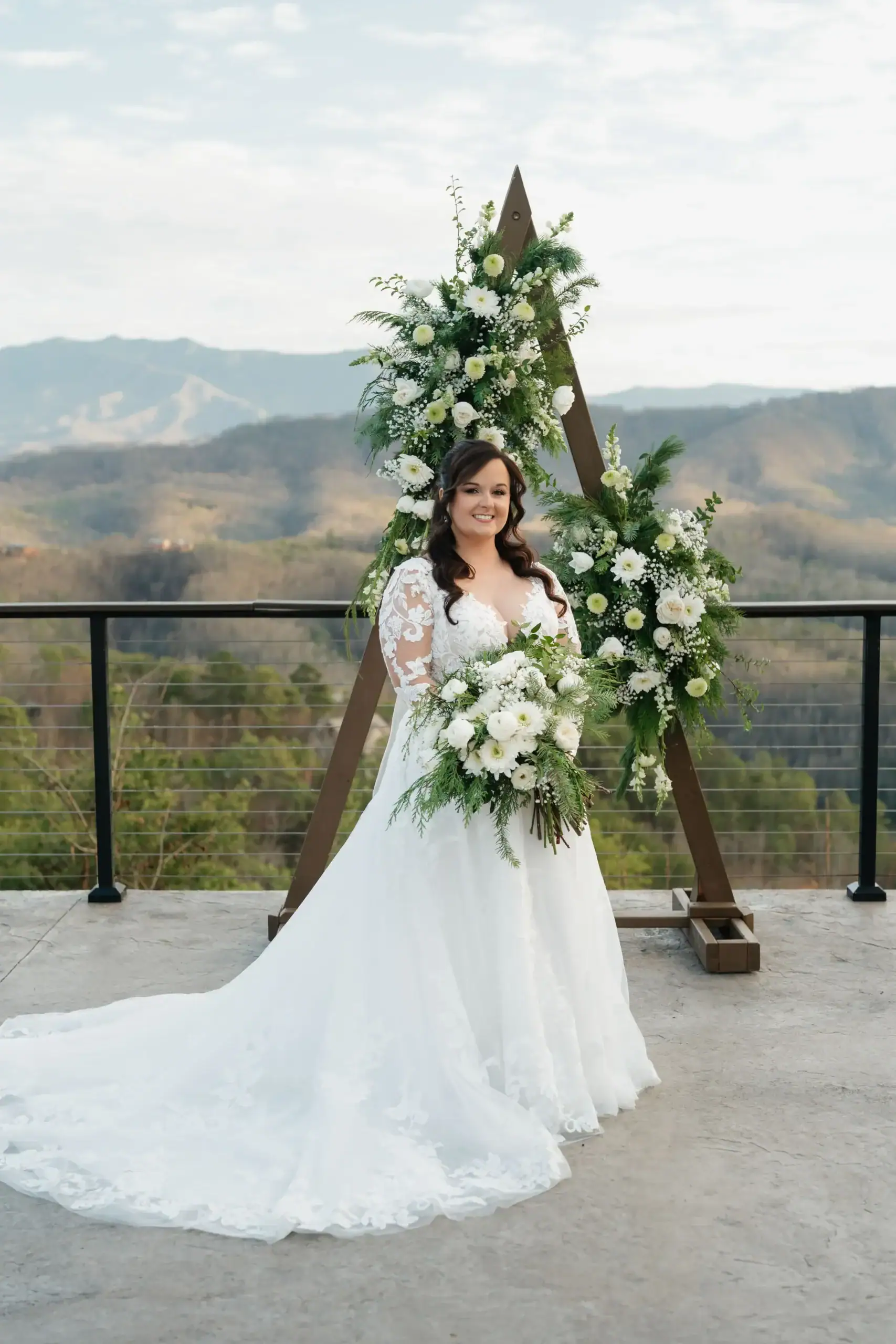 December wedding in the Smokies Bride is taking pictures with a mountain views at Magnolia wedding venue