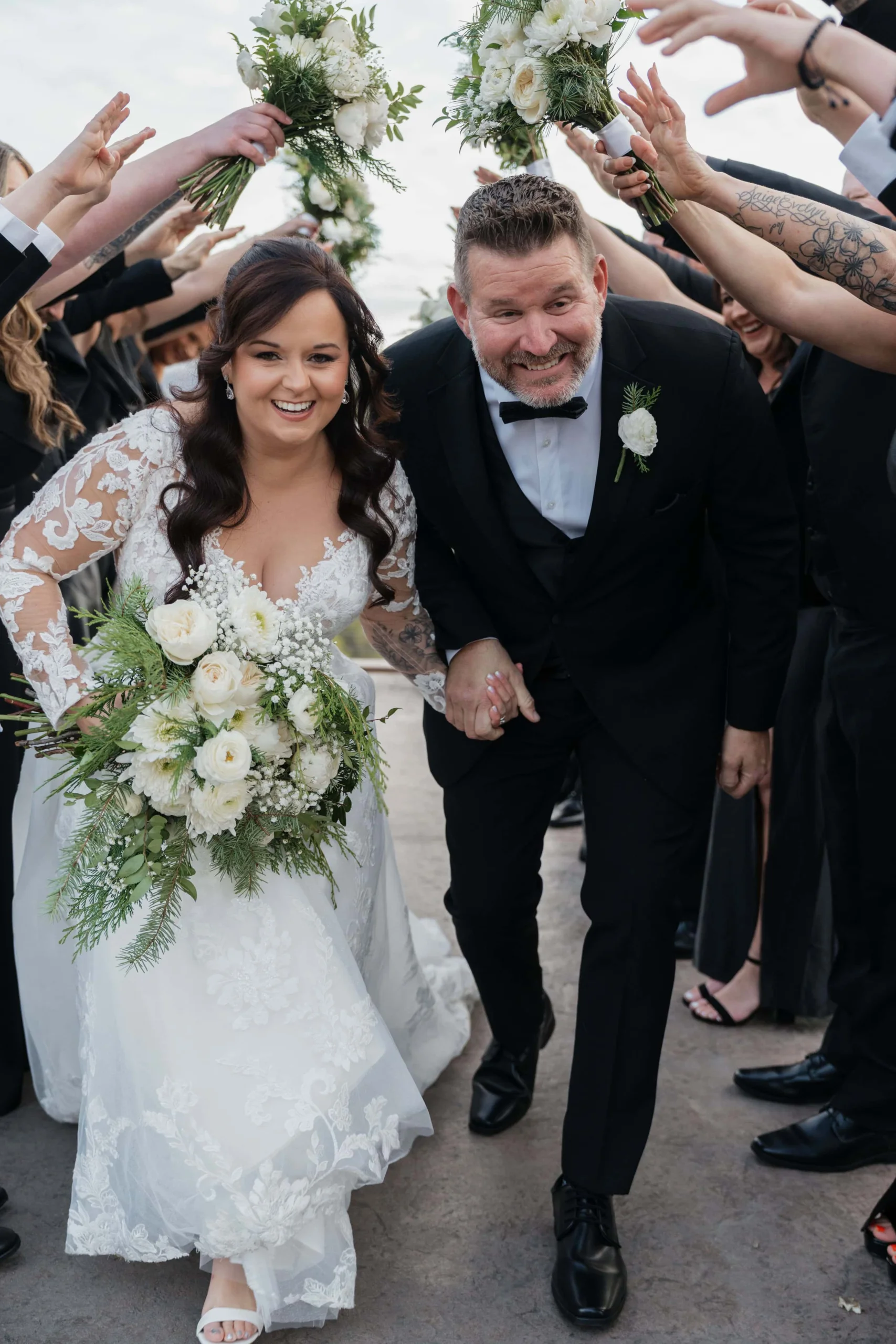 Joyful wedding exit at Magnolia Newly wed bride and groom running through cheering guests during wedding exit celebration