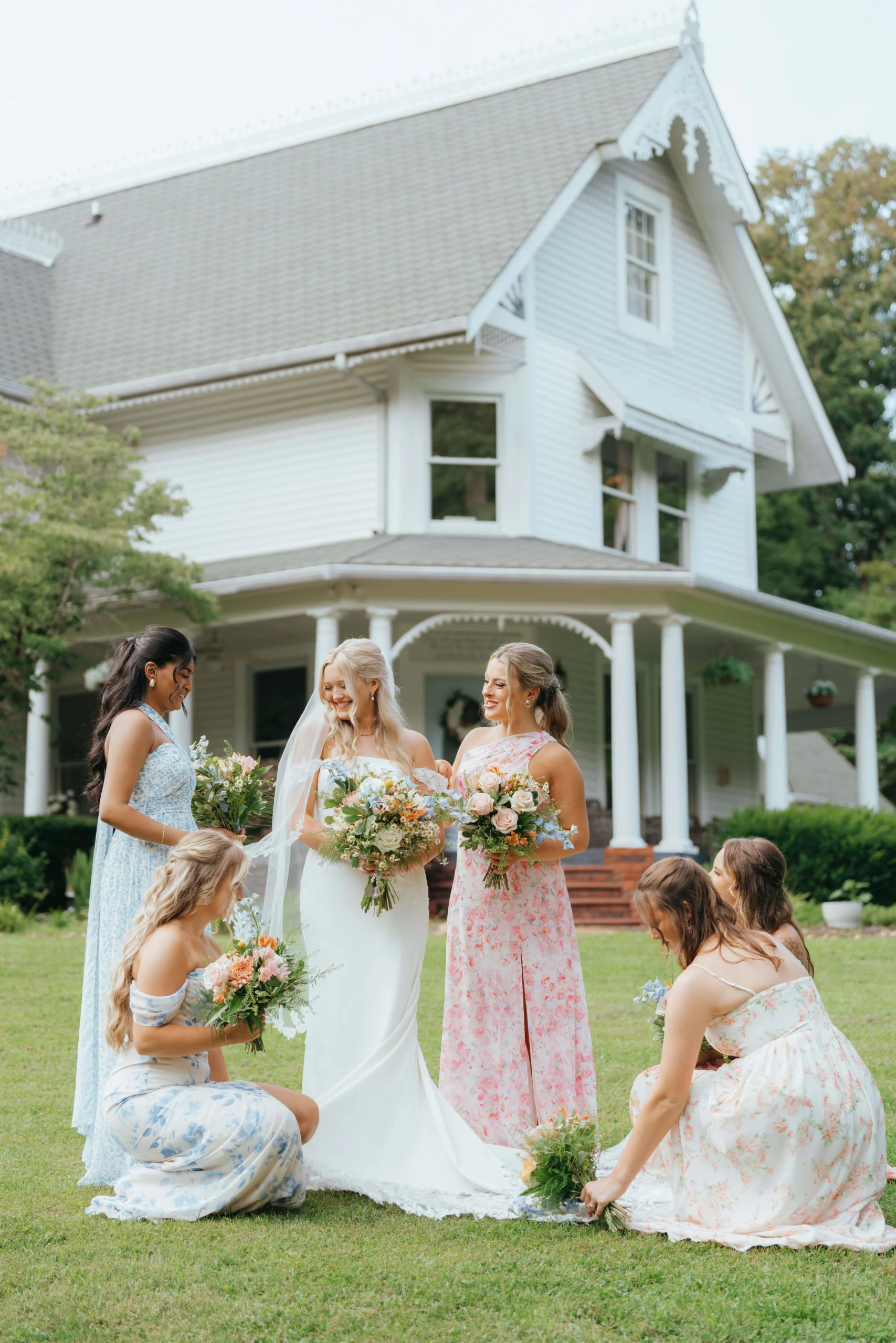 DSC05869 bride is taking photos with a bridesmaids during colorful summer wedding ceremony with blue yellow and pink florals in Knoxville Tennessee