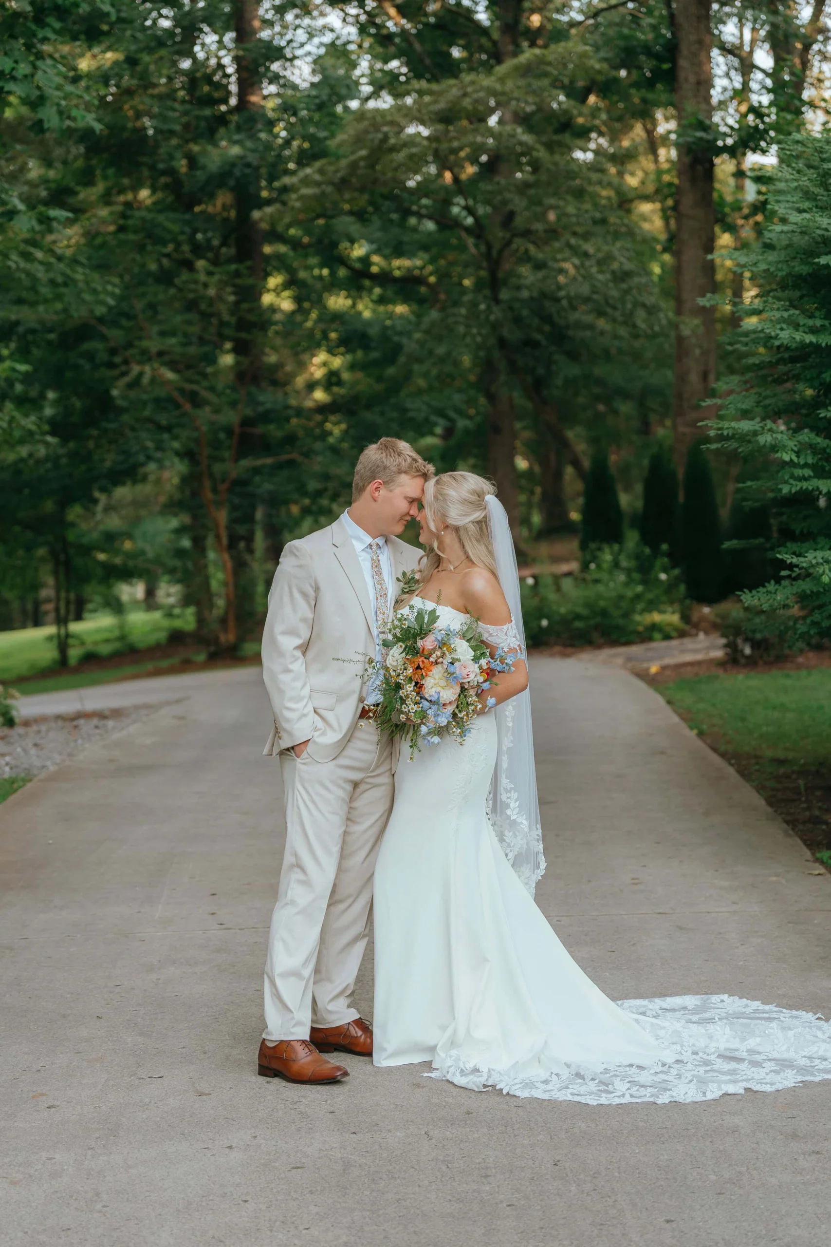 the Grand Victorian Couple embracing during sunset portraits at their Knoxville summer wedding